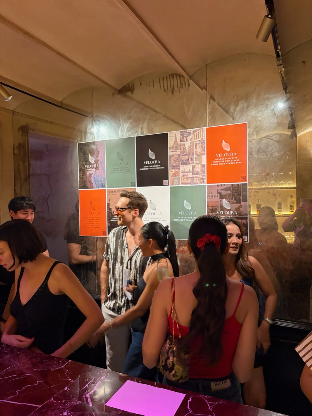 Guests by the bar at the Veloura launch