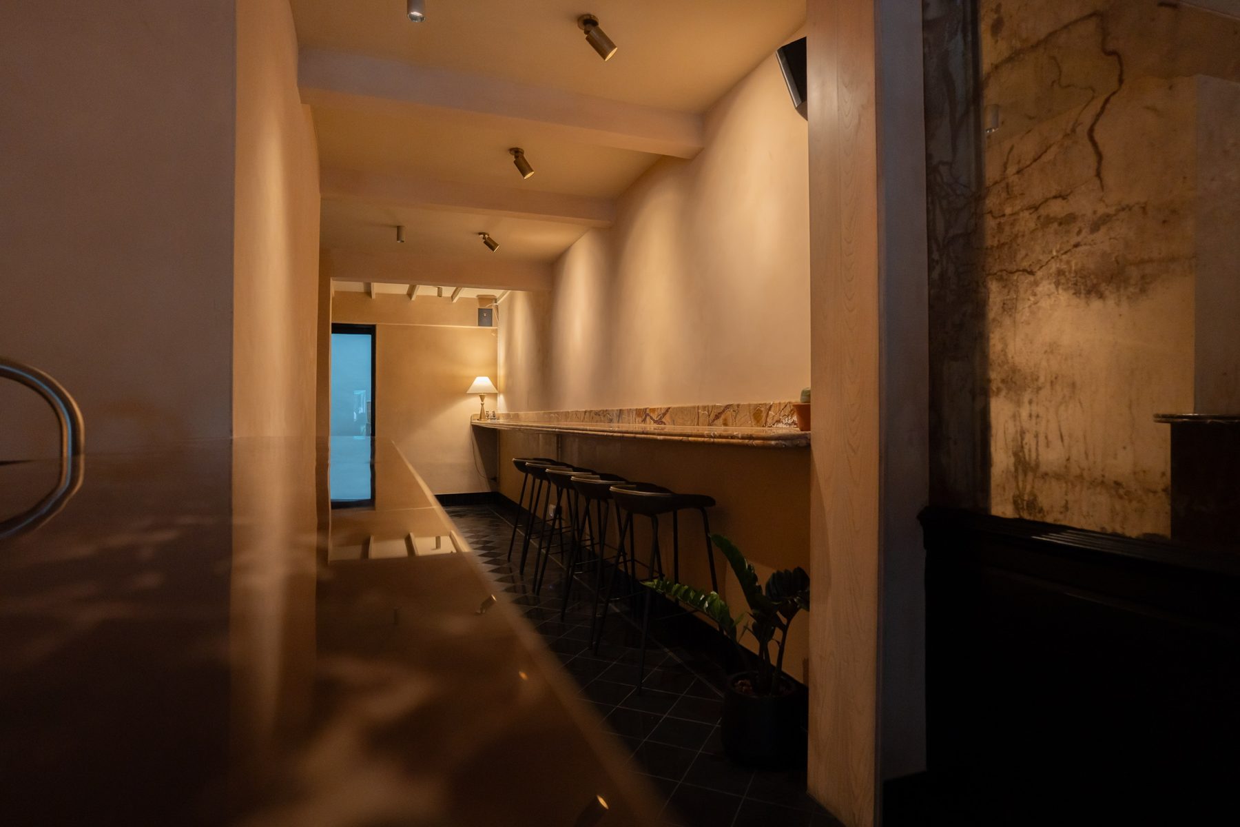 The gallery hall on the ground floor, lit along a long marble counter